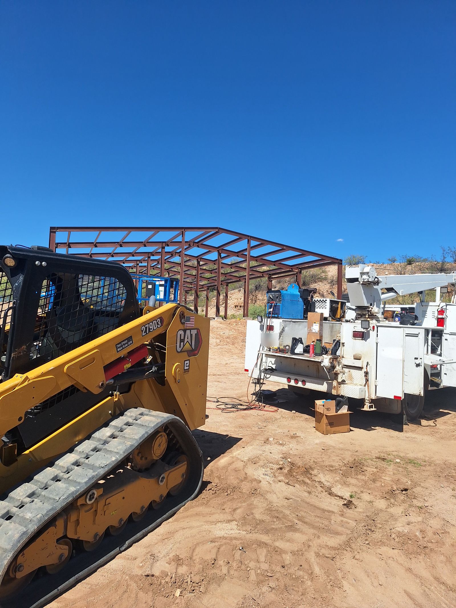 CAT skid steer next to service truck